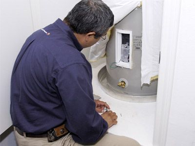Plumbing professional from Able Plumbing Repair Service, Inc. repairing a water heater in the Orange Park, FL