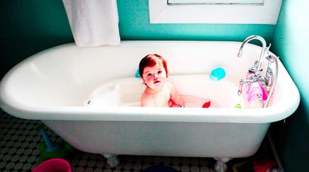 Toddler taking a bath in a clawfoot tub serviced by Able Plumbing Repair Service, Inc. in Orange Park, FL